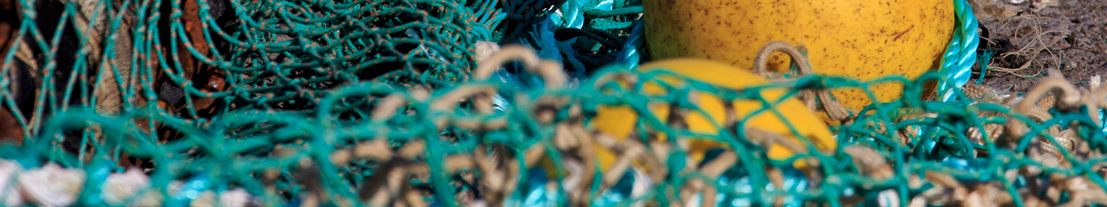 fishing gear, ropes, nets, yellow marker buoys on pier